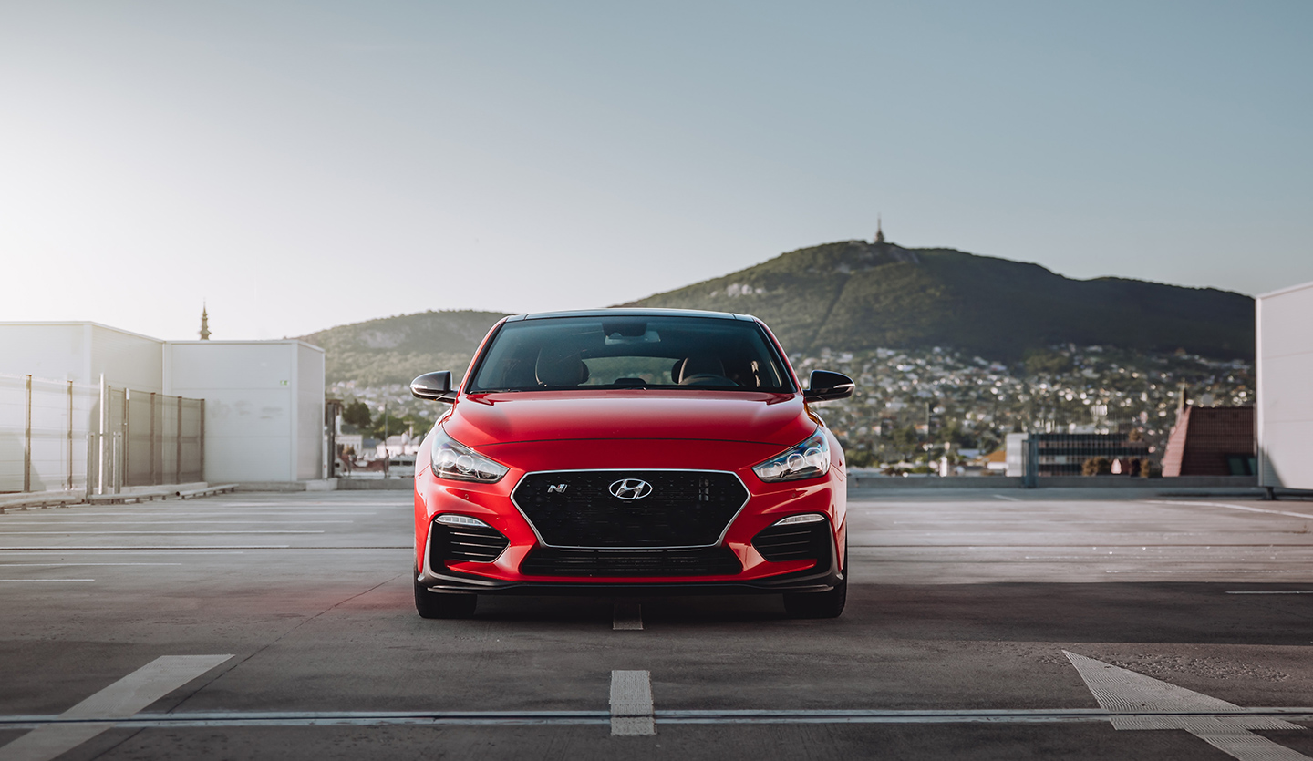 A red Hyundai car parked