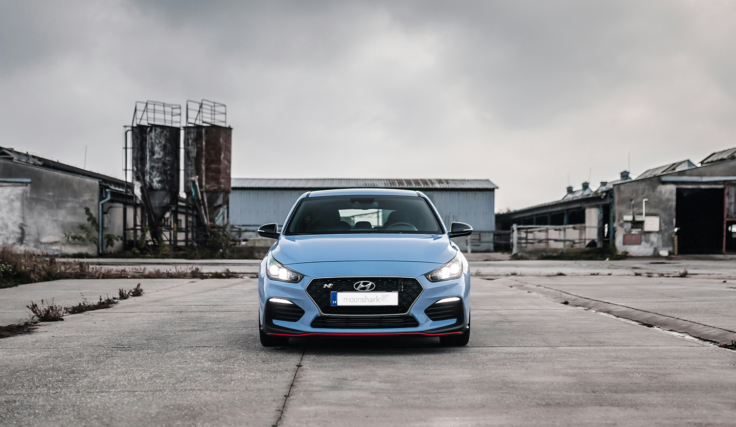 A red Hyundai car parked